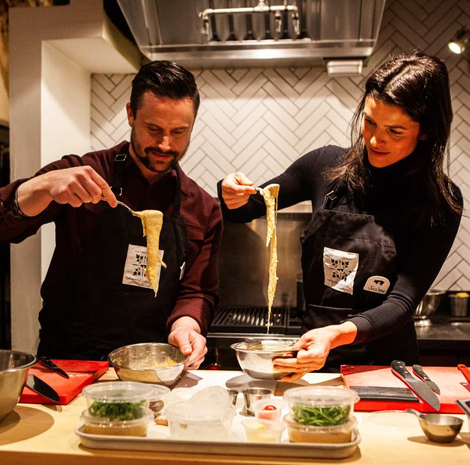  A couple preparing a meal together in a cooking class.